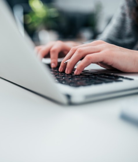 Person typing on keyboard